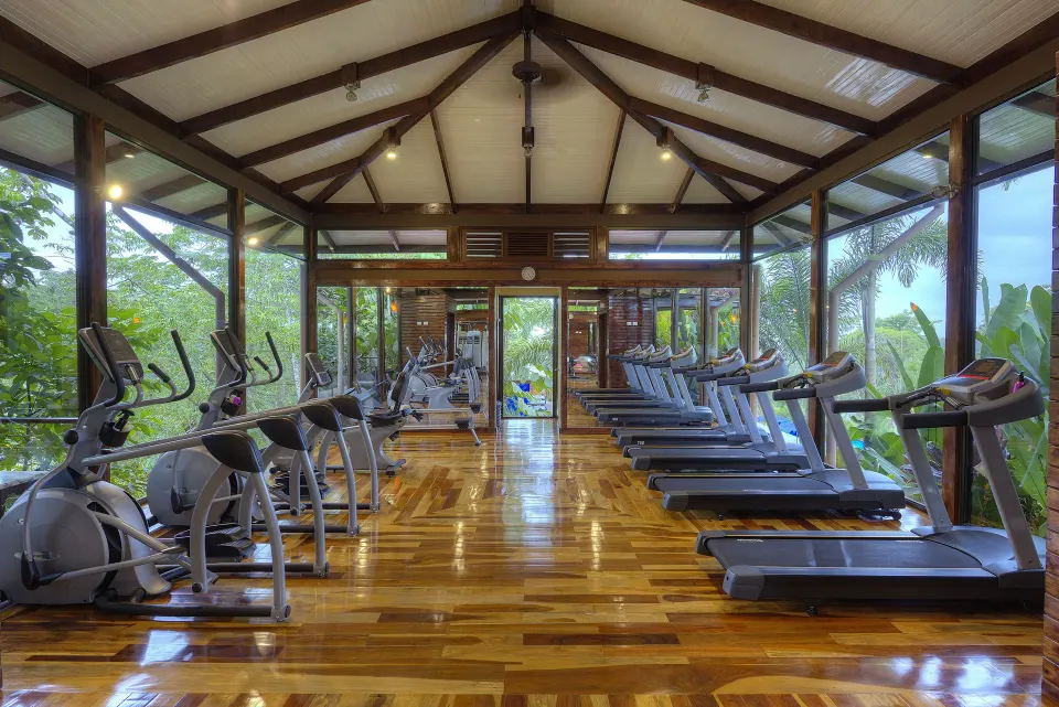 Fitness room with treadmills and cardio machines at Nayara Springs.