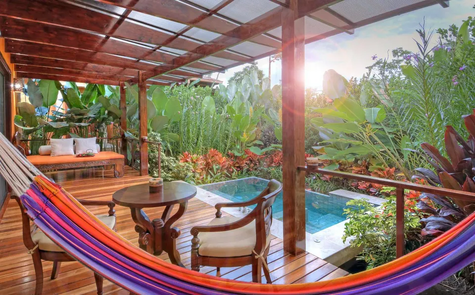 Hammock and seating on a private villa deck at Nayara Springs.