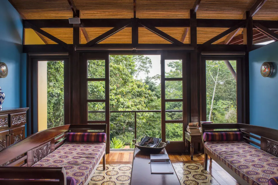 Spa lounge with twin daybeds and open windows to the forest at Nayara Springs.