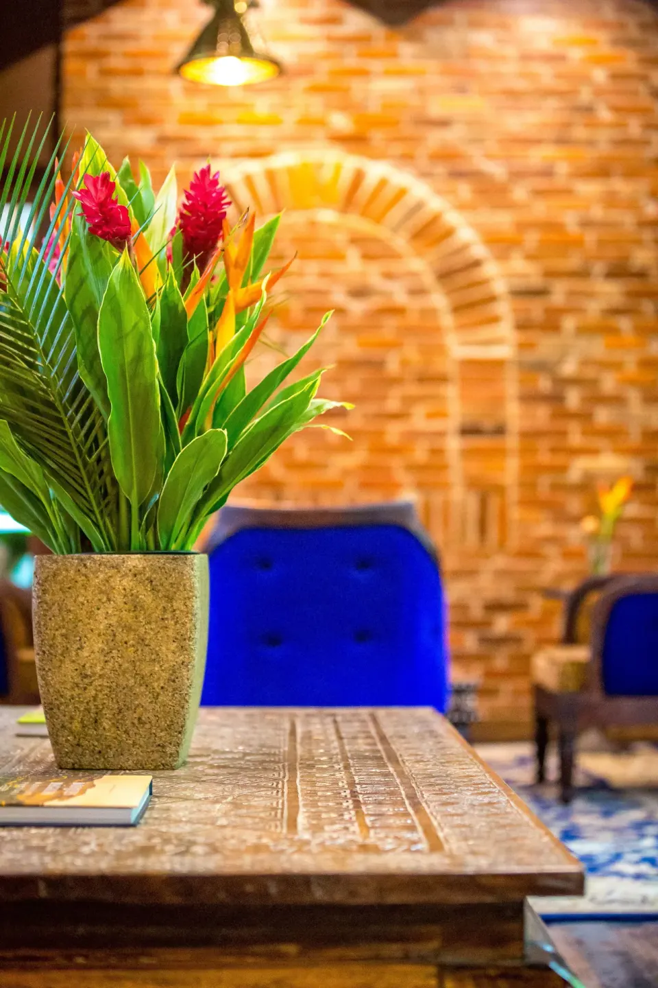Tropical flowers on a carved table in a lounge at Nayara Springs.