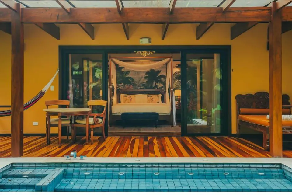 Guest villa terrace with pool and canopy bed at Nayara Springs.