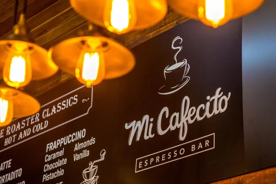 Mi Cafecito espresso bar sign and menu boards at Nayara Springs.
