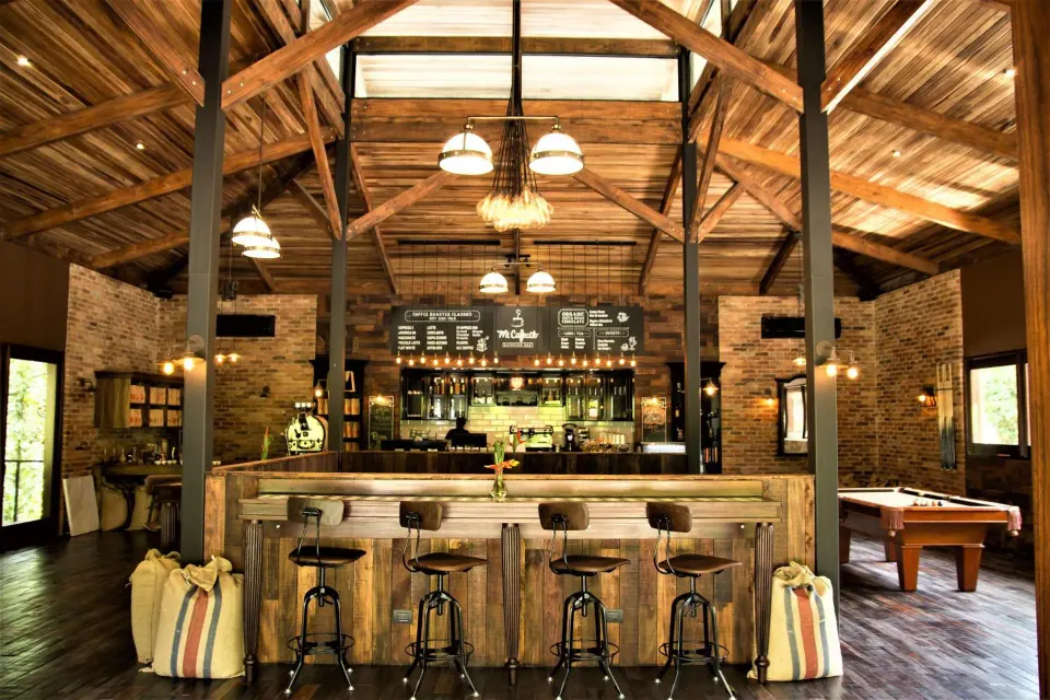 Rustic coffee bar with counter seating and chalkboard menus at Nayara Springs.