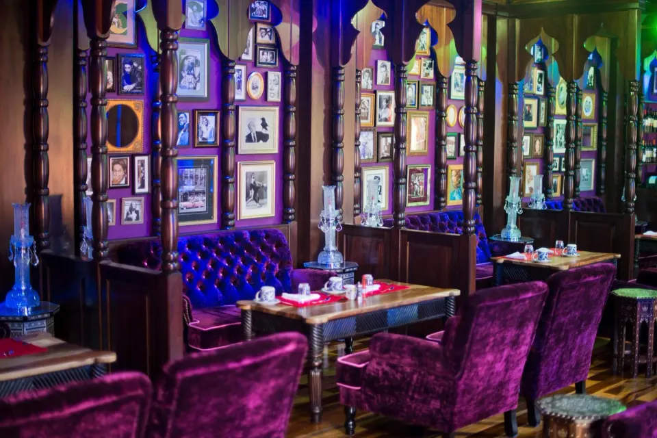 Plush purple lounge seating inside Nostalgia Wine Bar at Nayara Springs.