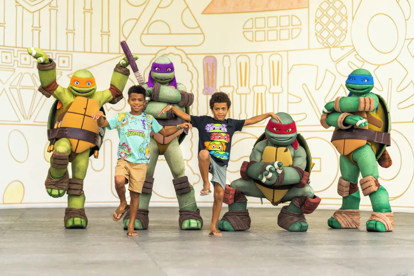 Children pose with costumed turtle characters at Nickelodeon Hotels & Resorts Riviera Maya.