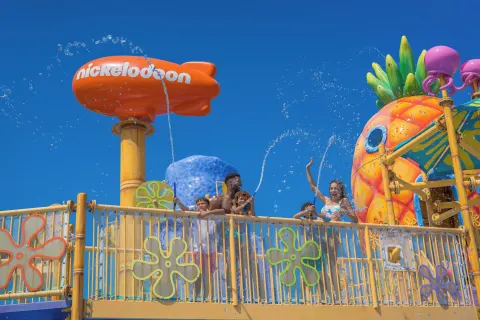 Guests stand on an elevated splash deck at Nickelodeon Hotels & Resorts Riviera Maya.