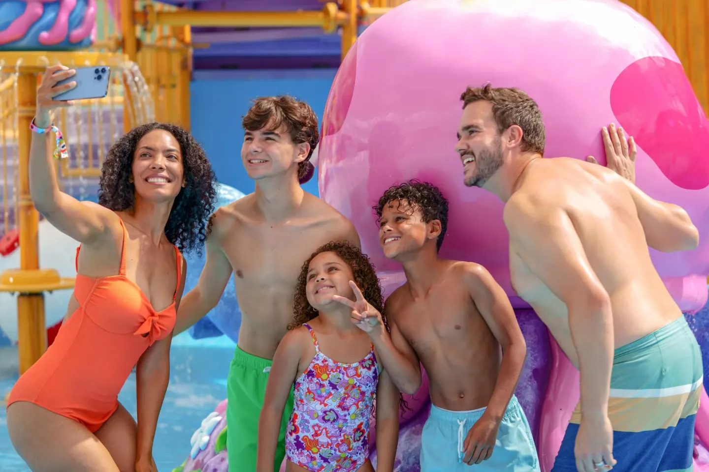 Family takes a selfie by a pink pool sculpture at Nickelodeon Hotels & Resorts Riviera Maya.