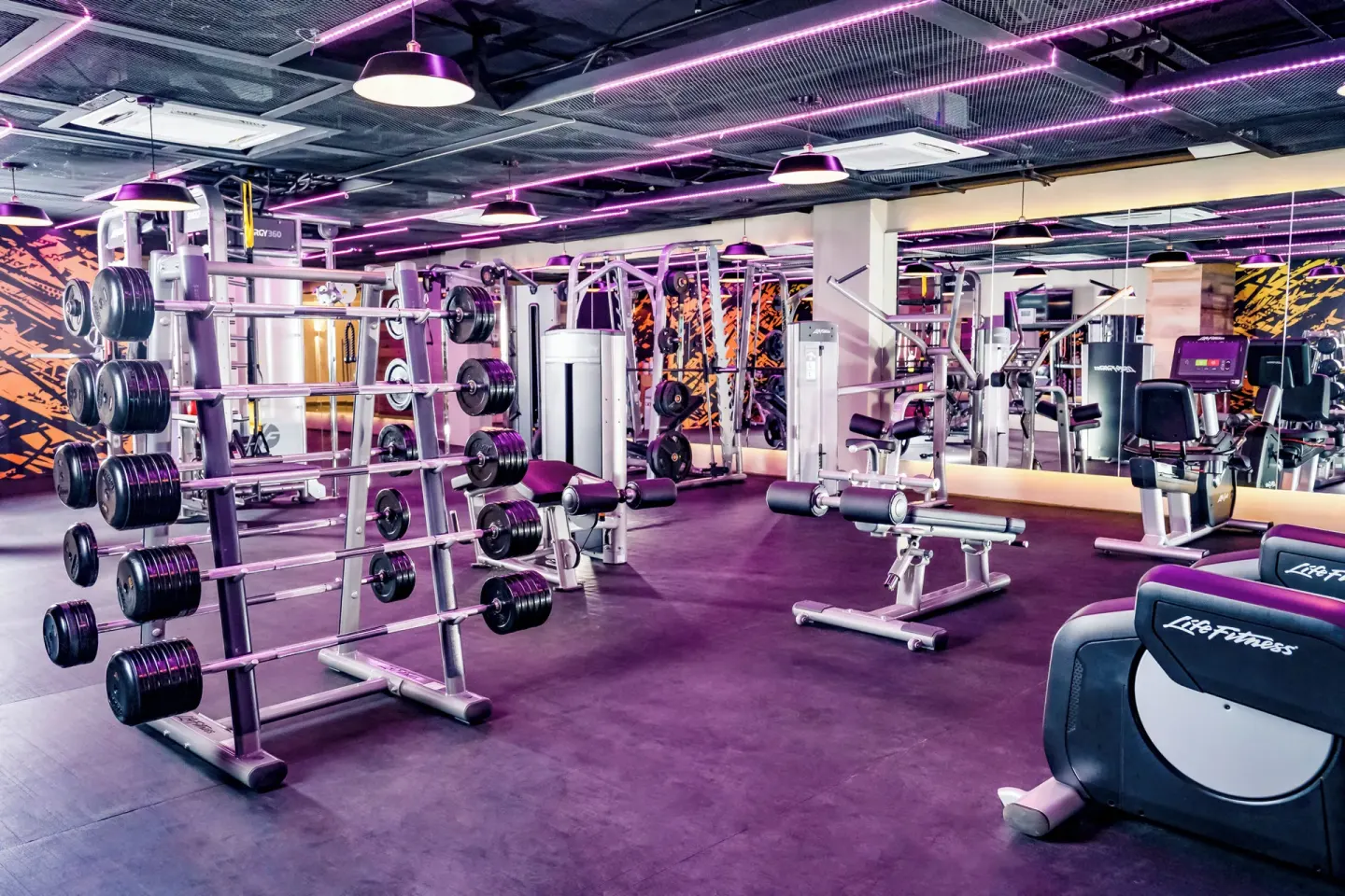A fitness center with weights and cardio machines at Nickelodeon Hotels & Resorts Riviera Maya.