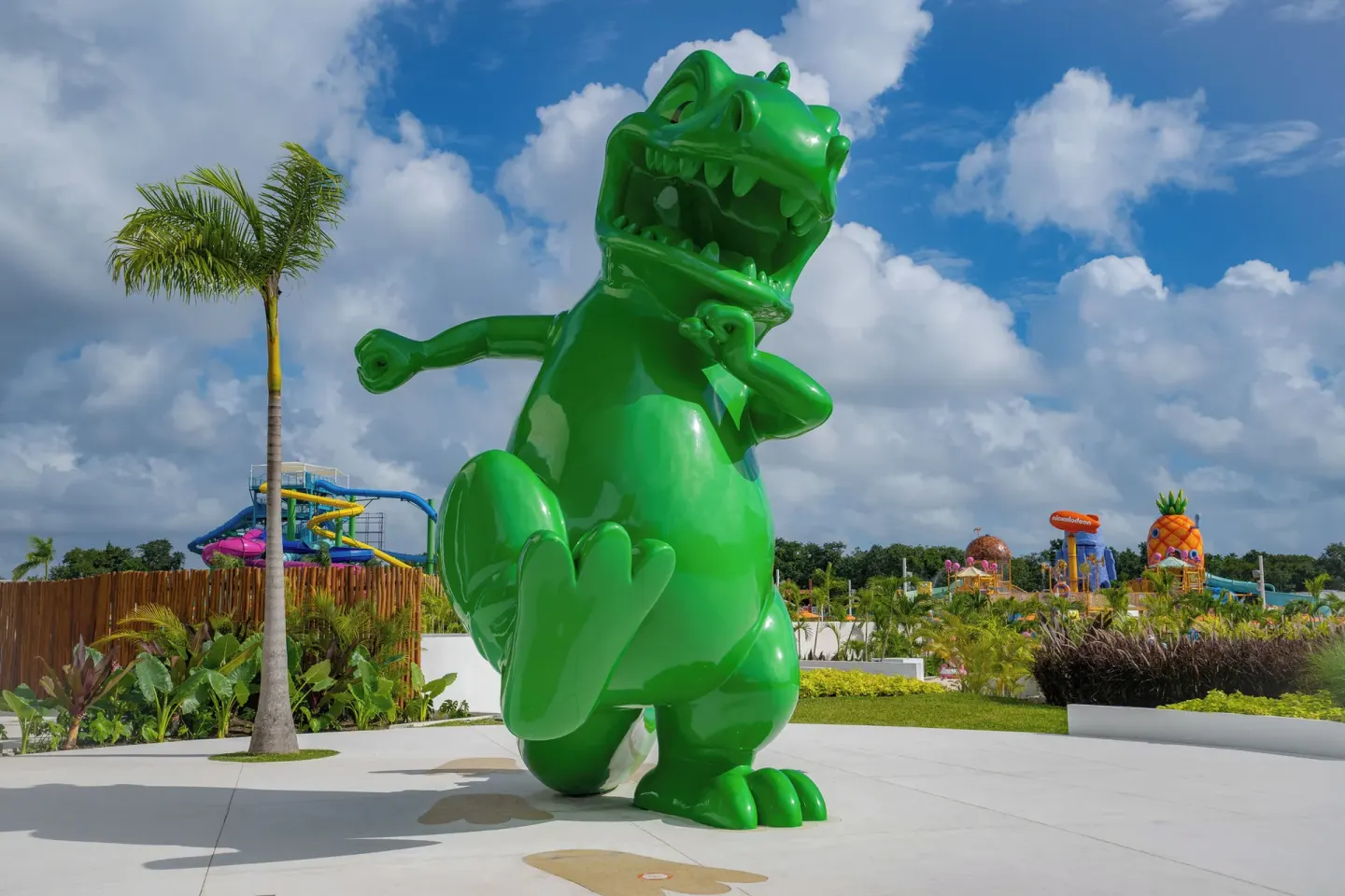 A large green character statue stands near the water park at Nickelodeon Hotels & Resorts Riviera Maya.