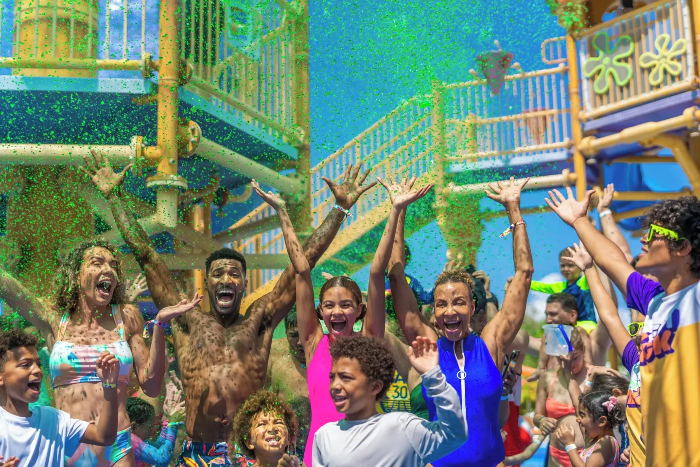 Guests cheer under a burst of green slime at Nickelodeon Hotels & Resorts Riviera Maya.