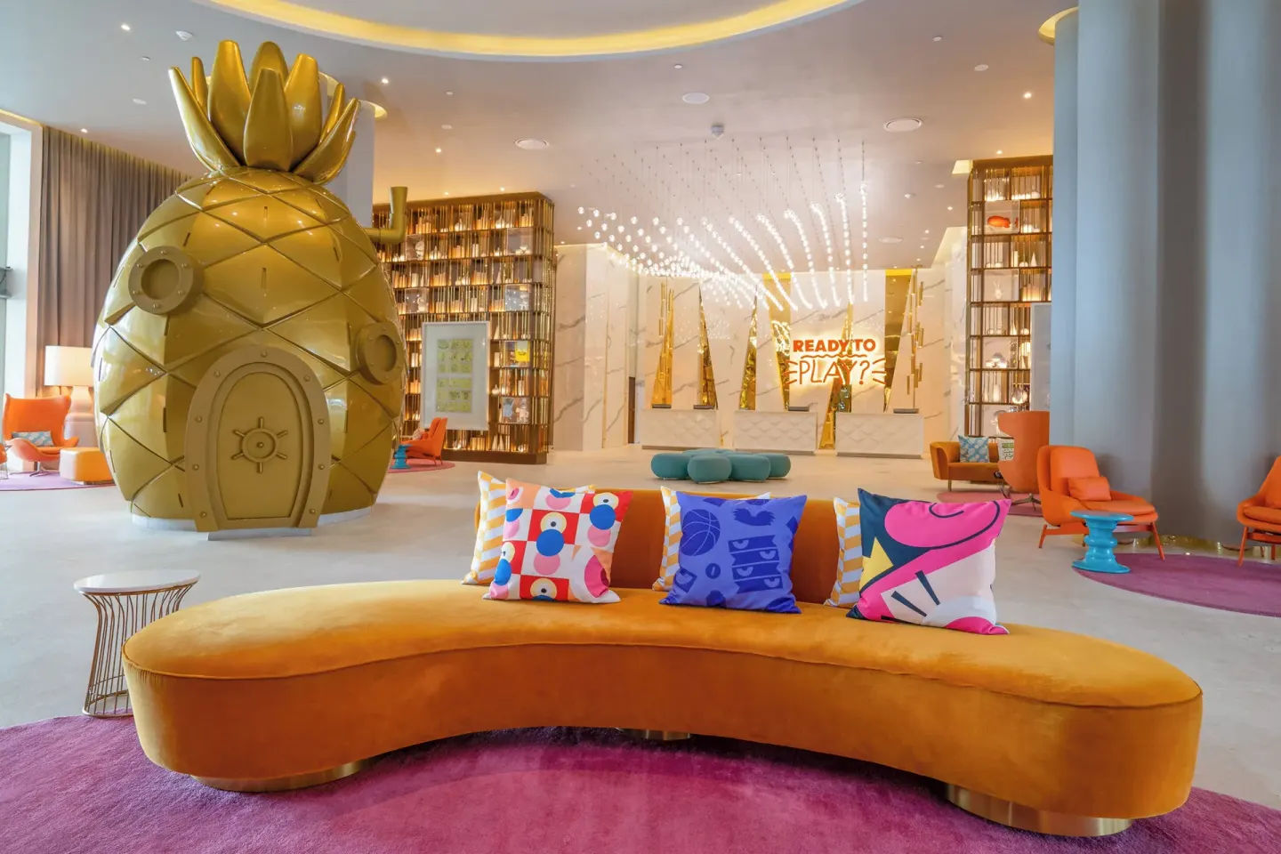 Lobby lounge with a giant pineapple sculpture at Nickelodeon Hotels & Resorts Riviera Maya.
