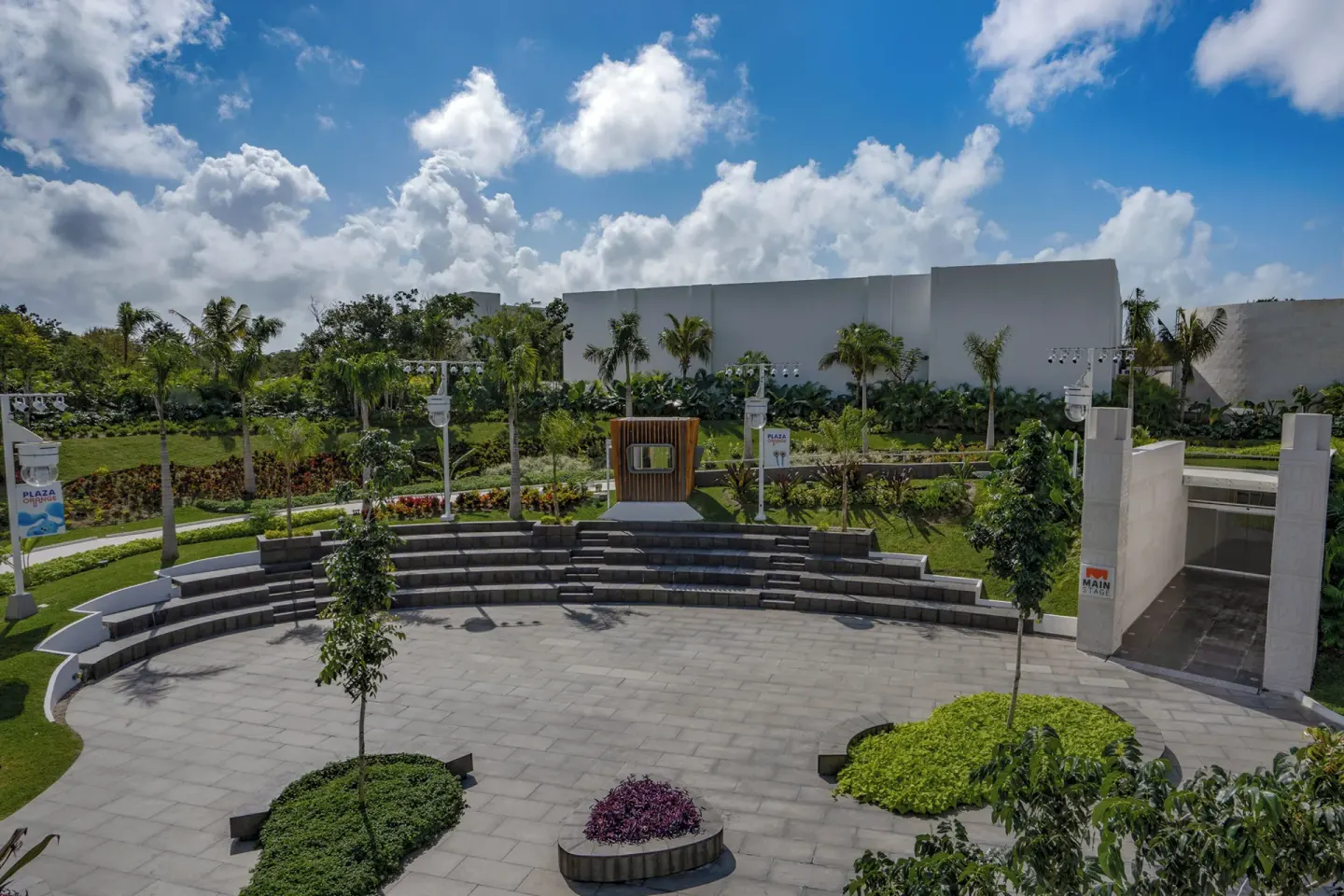 An outdoor amphitheater plaza with landscaping at Nickelodeon Hotels & Resorts Riviera Maya.