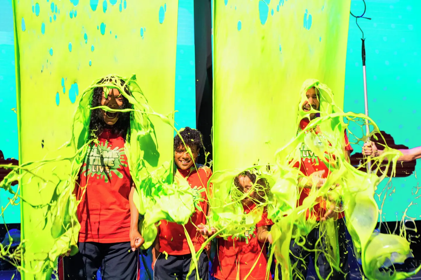 Children are splashed with green slime on stage at Nickelodeon Hotels & Resorts Riviera Maya.