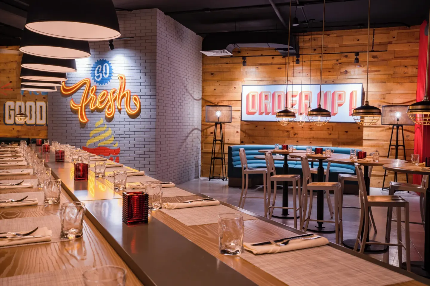 Good Burger dining area with neon signs at Nickelodeon Hotels & Resorts Riviera Maya.