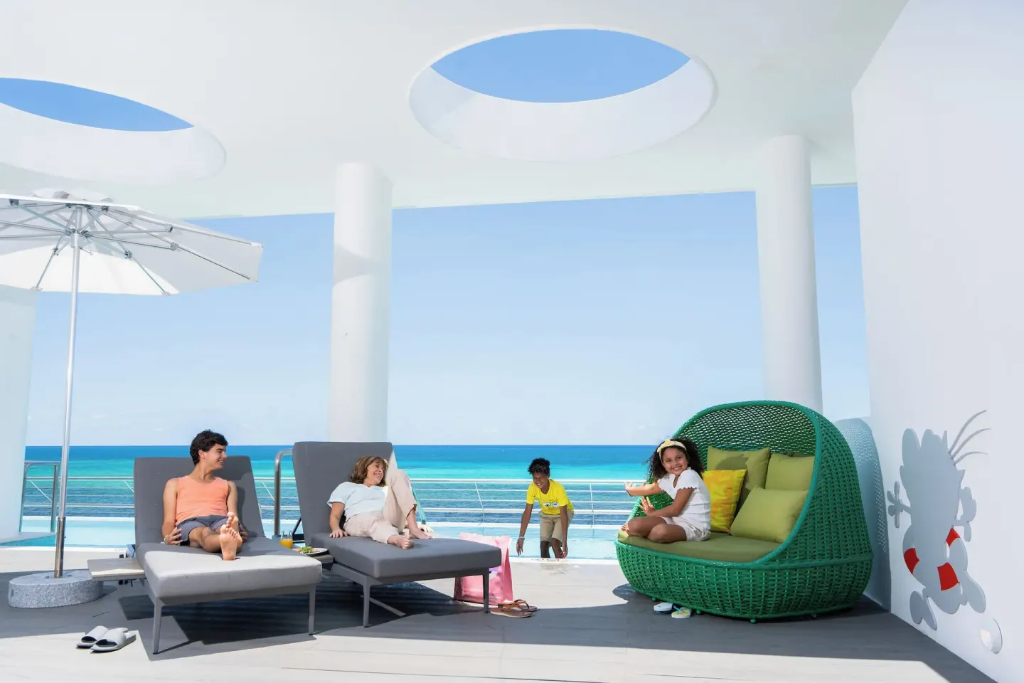 Big Kahuna Suite oceanfront terrace with loungers and seating at Nickelodeon Hotels & Resorts Riviera Maya.