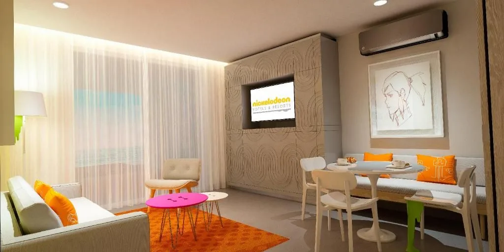 Penthouse Oceanfront Swim-Up Suite living area with TV at Nickelodeon Hotels & Resorts Riviera Maya.