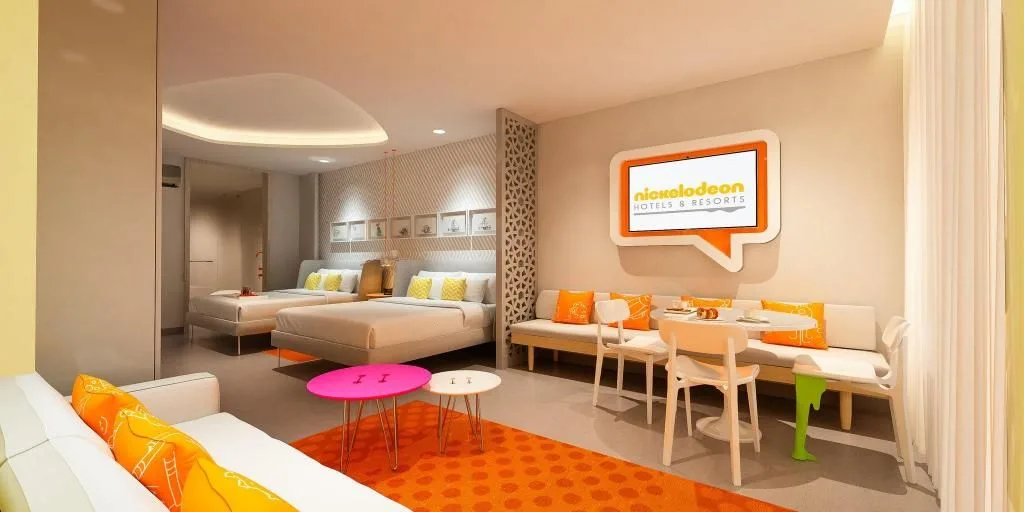 Penthouse Oceanfront Swim-Up Suite living space and two beds at Nickelodeon Hotels & Resorts Riviera Maya.