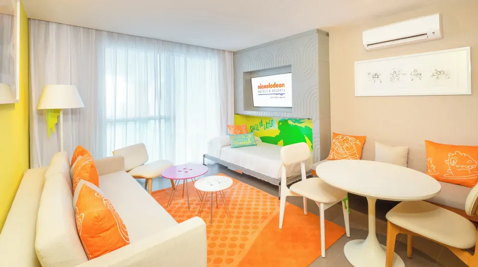Oceanfront Swim-Up Suite lounge with daybed at Nickelodeon Hotels & Resorts Riviera Maya.
