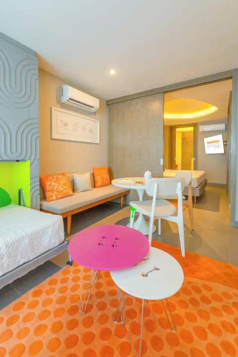 Oceanfront Swim-Up Suite living area with daybed at Nickelodeon Hotels & Resorts Riviera Maya.