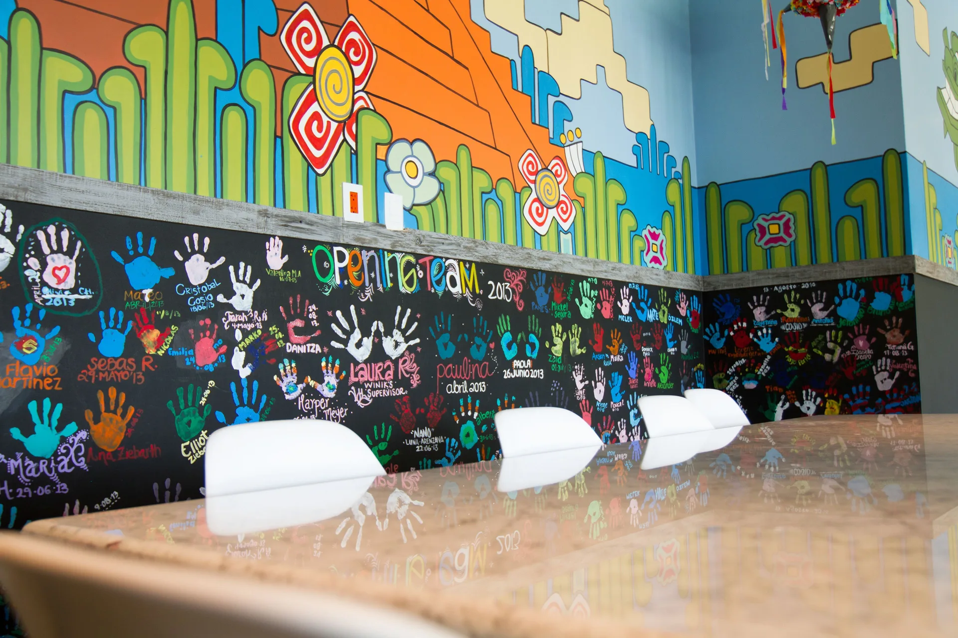 Colorful children's room mural and handprint wall at Nizuc Resort and Spa.