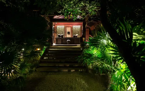 Illuminated garden walkway leading to a pavilion at Nizuc Resort and Spa.