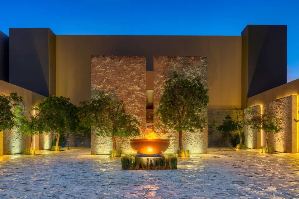 Illuminated stone entrance courtyard at Nizuc Resort and Spa.