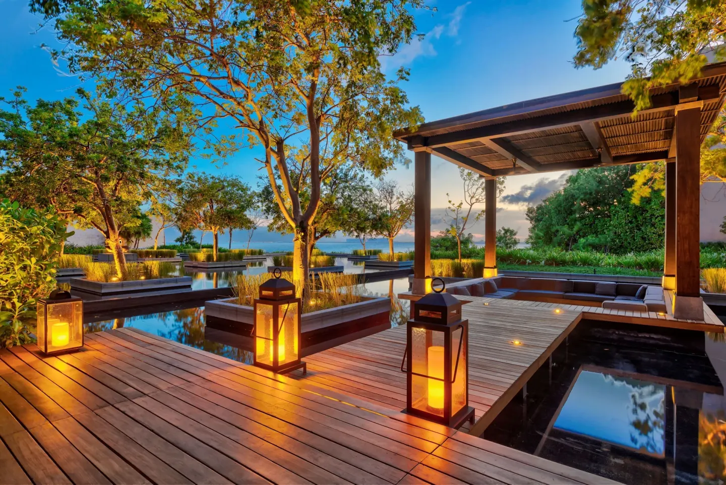 Lantern-lit wooden deck and water features at Nizuc Resort and Spa.