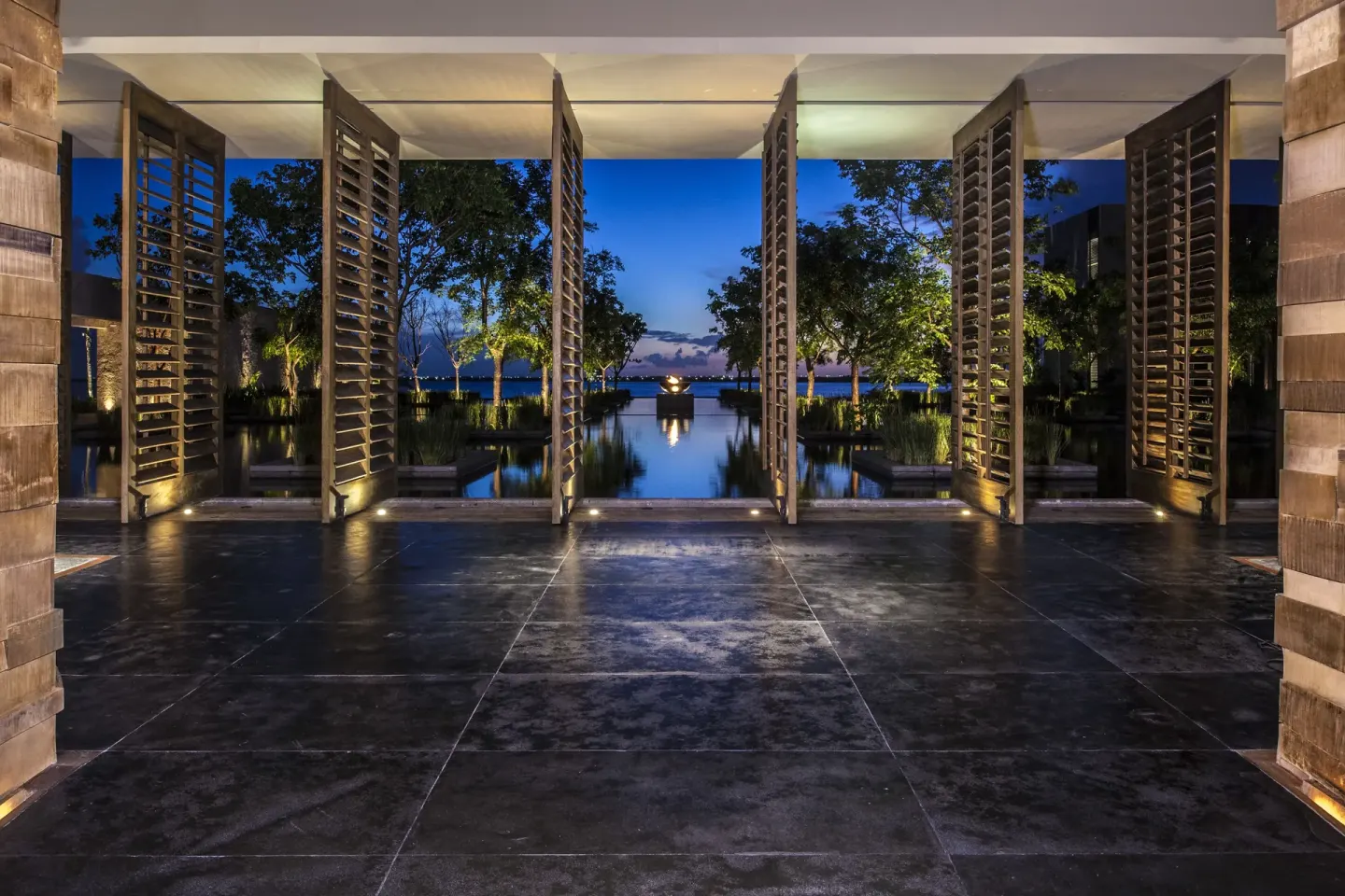 Lobby entrance with louvered screens and garden pools at Nizuc Resort and Spa.
