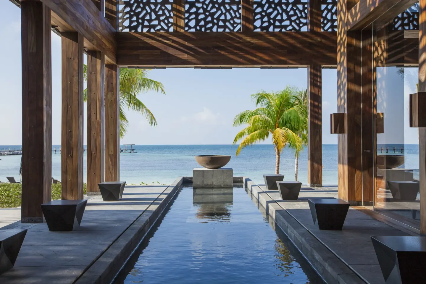 Open-air oceanfront passage with water feature at Nizuc Resort and Spa.