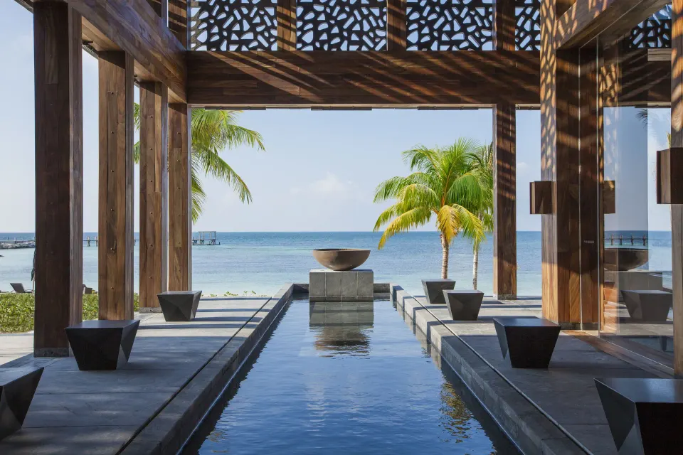 Open-air oceanfront passage with water feature at Nizuc Resort and Spa.