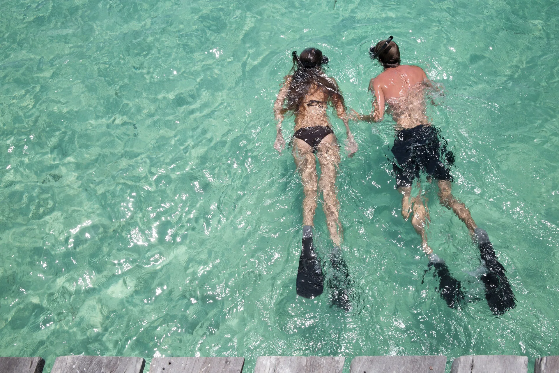 Two snorkelers swim in clear turquoise water at Nizuc Resort and Spa.