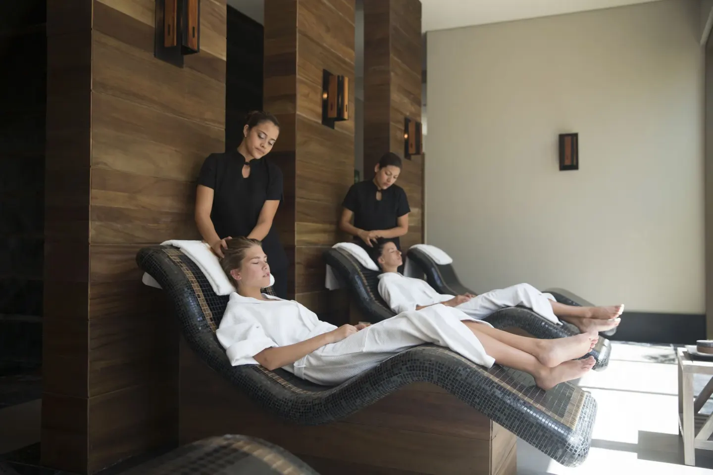 Guests receive head treatments on heated loungers in the spa at Nizuc Resort and Spa.