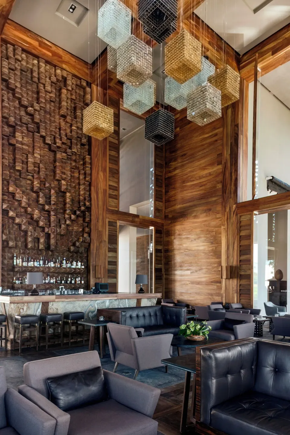 Tall bar lounge with cube pendant lights at Nizuc Resort and Spa.