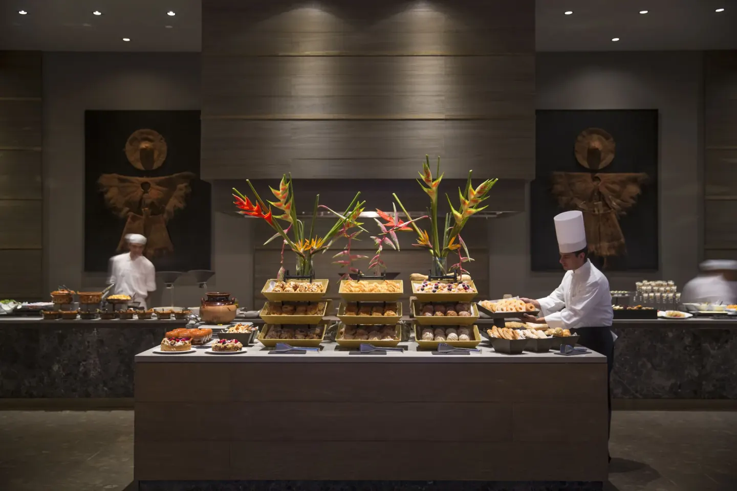Breakfast buffet with chefs, pastries, and tropical flowers at Nizuc Resort and Spa.