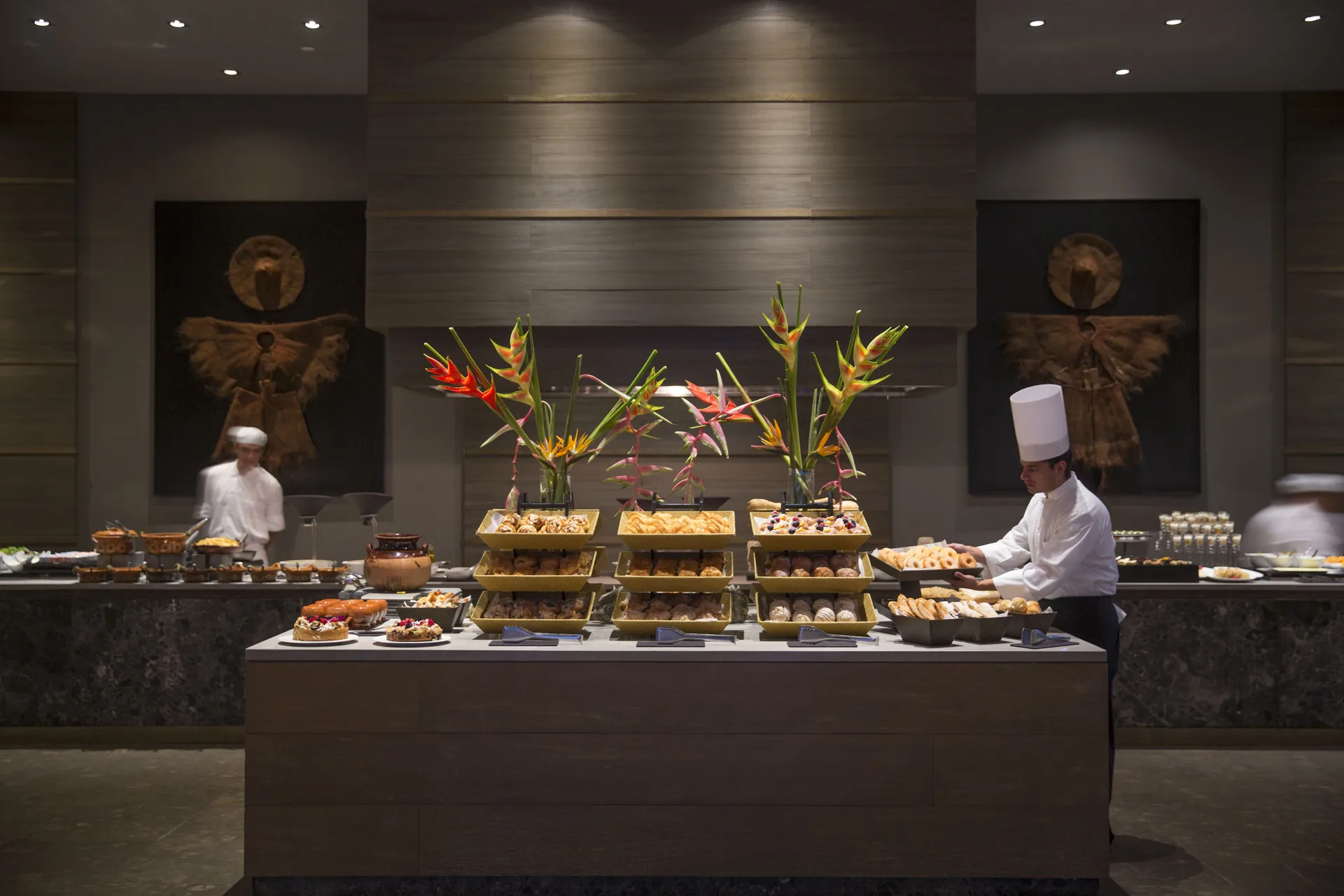 Breakfast buffet with chefs, pastries, and tropical flowers at Nizuc Resort and Spa.