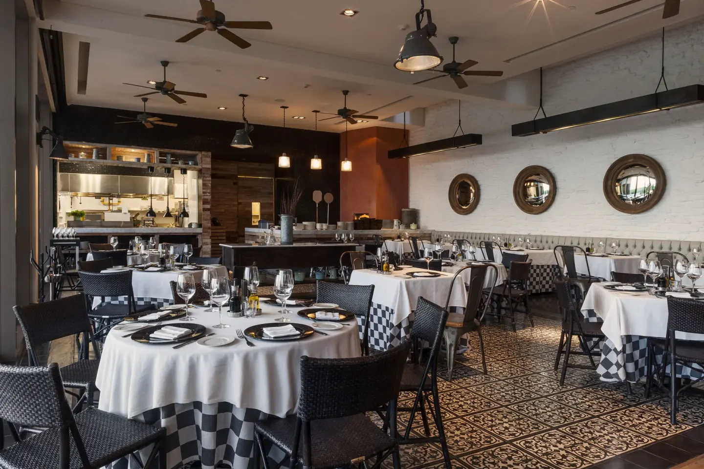 Checkered tablecloths and an open kitchen in a restaurant at Nizuc Resort and Spa.