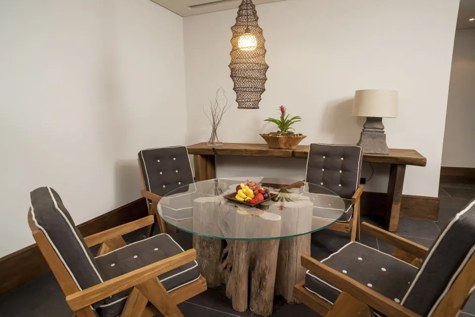 Garden Deluxe Suite dining nook with round glass table at Nizuc Resort and Spa.