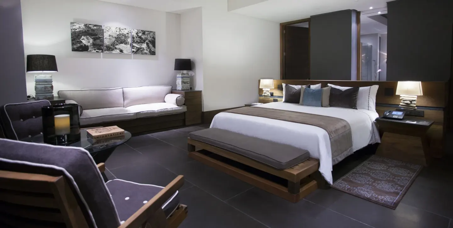Junior Suite garden king bed and lounge seating at Nizuc Resort and Spa.