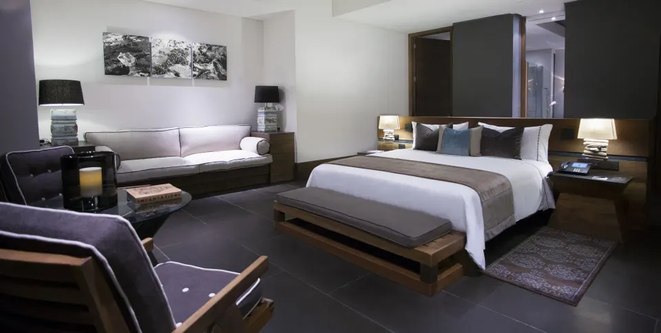 Junior Suite garden king bed and lounge seating at Nizuc Resort and Spa.
