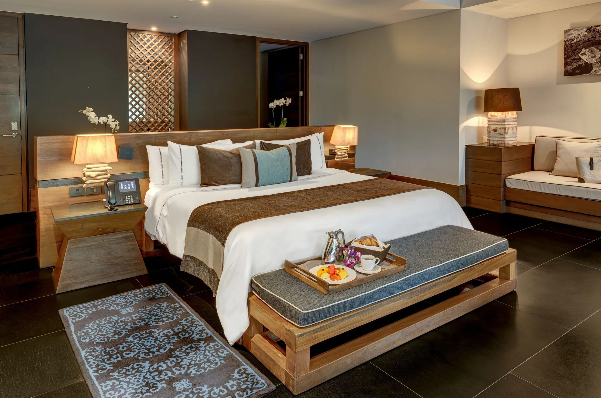 Junior Suite Ocean View king bed with bench and sofa at Nizuc Resort and Spa.