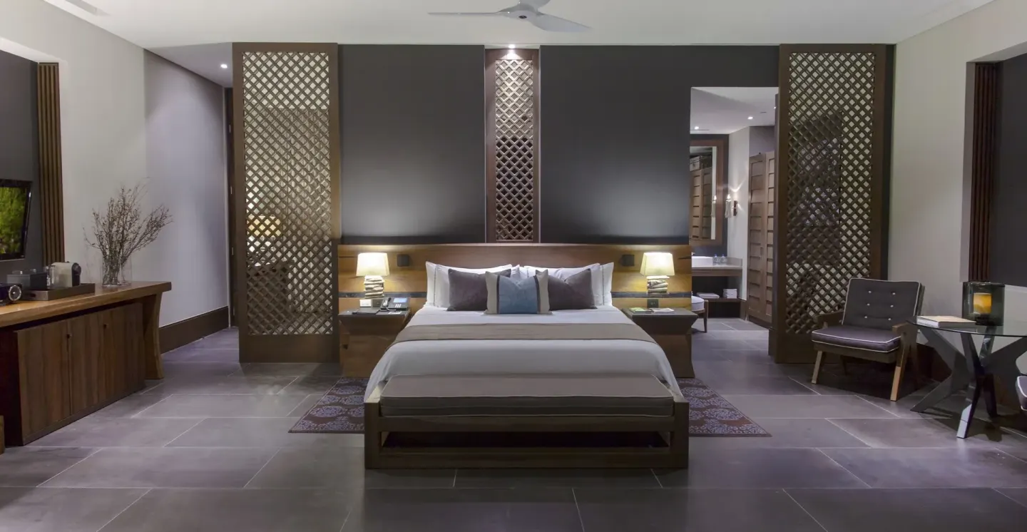 Ocean Suite bedroom with king bed and lattice screens at Nizuc Resort and Spa.