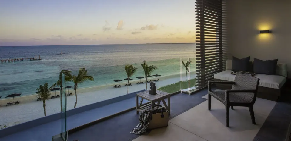 Ocean Suite terrace at sunset with seating and beach view at Nizuc Resort and Spa.