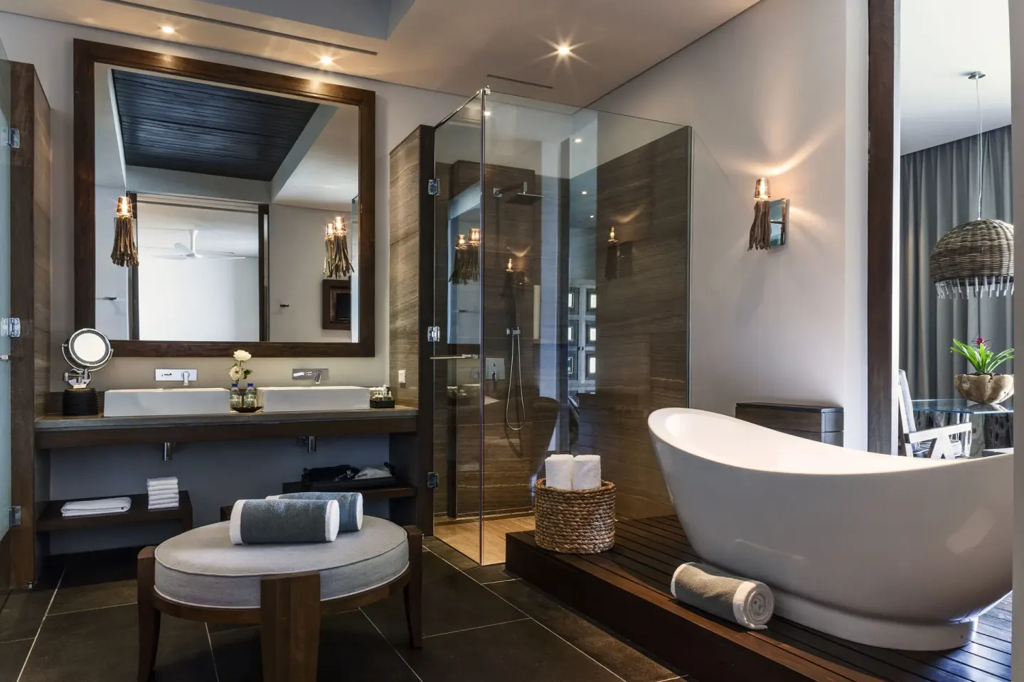 Penthouse bathroom with freestanding tub, glass shower and vanity at Nizuc Resort and Spa.