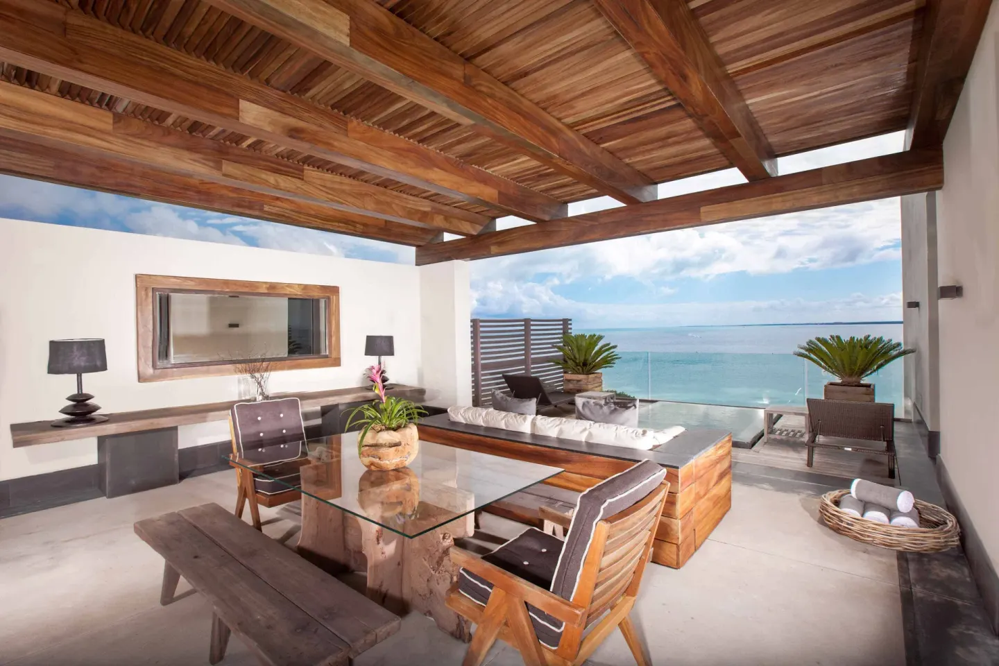 Penthouse terrace with dining table, lounge seating and water view at Nizuc Resort and Spa.