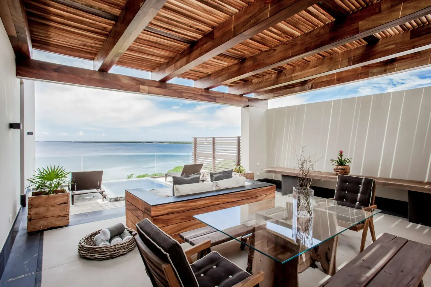 Penthouse terrace dining and lounge area overlooking the water at Nizuc Resort and Spa.