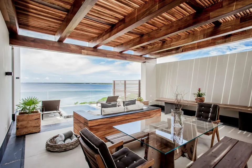 Penthouse terrace dining and lounge area overlooking the water at Nizuc Resort and Spa.
