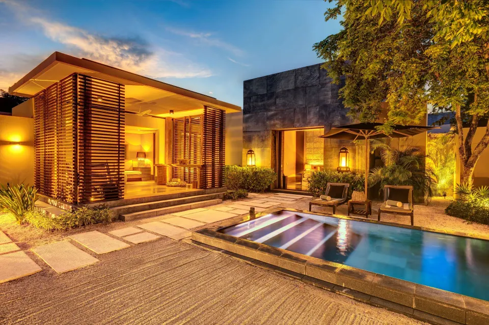 Private Pool Pavilion Villa courtyard pool illuminated at dusk at Nizuc Resort and Spa.