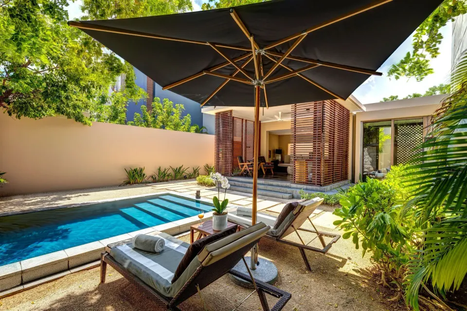 Private Pool Pavilion Villa pool patio with loungers and umbrella at Nizuc Resort and Spa.