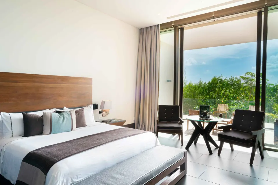 Garden view king bed room with balcony greenery at Nizuc Resort and Spa.