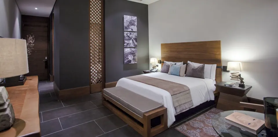 Garden view king bed room with wood headboard at Nizuc Resort and Spa.